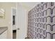 Bathroom showing decorative shower curtain, white door, and access to bedroom at 6356 Raleigh St # 1512, Orlando, FL 32835