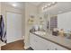 Bright bathroom features a granite countertop, white cabinets, and decorative shelving at 6356 Raleigh St # 1512, Orlando, FL 32835