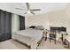 Bedroom featuring neutral walls, a ceiling fan, and a large window for natural light at 6356 Raleigh St # 1512, Orlando, FL 32835