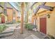 Charming townhome featuring a cozy patio, lush landscaping, and a welcoming red front door with a modern design at 6356 Raleigh St # 1512, Orlando, FL 32835