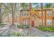 Charming townhome with a red door, lush landscaping, and a cozy patio area in a desirable community at 6356 Raleigh St # 1512, Orlando, FL 32835