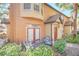 Inviting patio area with outdoor seating, complemented by lush green landscaping and a welcoming red front door at 6356 Raleigh St # 1512, Orlando, FL 32835