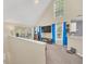 Bright living room with vaulted ceilings, large windows, and stylish blue curtains creating an inviting atmosphere at 6356 Raleigh St # 1512, Orlando, FL 32835
