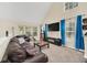 Spacious living room with vaulted ceilings, large windows, and a comfortable leather sofa and a view of the neighborhood at 6356 Raleigh St # 1512, Orlando, FL 32835