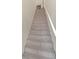 Carpeted staircase leads to the upper level, providing access to the home's bedrooms and additional living spaces at 6356 Raleigh St # 1512, Orlando, FL 32835