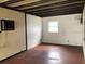 Finished basement room with vintage air conditioner and access to electrical box at 6429 Voltaire Dr, Orlando, FL 32809
