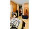 Bedroom with an open closet featuring bi-fold doors and wood-paneled walls at 6429 Voltaire Dr, Orlando, FL 32809