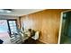 Bright dining area featuring wood paneled walls and sliding glass doors to lanai at 6429 Voltaire Dr, Orlando, FL 32809