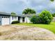 Home boasts an attached garage and well-maintained landscaping at 6429 Voltaire Dr, Orlando, FL 32809