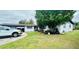 A house with a grass lawn and parked vehicles at 6429 Voltaire Dr, Orlando, FL 32809