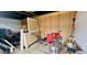 Messy garage interior, with a lawn mower and other items at 6429 Voltaire Dr, Orlando, FL 32809