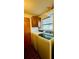 Well-lit laundry area with washer, dryer, overhead cabinets, and a window at 6429 Voltaire Dr, Orlando, FL 32809