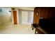 Spacious living room with wood paneled walls, offering lots of natural light at 6429 Voltaire Dr, Orlando, FL 32809