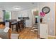 A light-filled dining area with wood floors, with seating for Gathering meals at 8123 Shelley Trl, Kissimmee, FL 34747