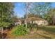 Well-maintained backyard with lush greenery, mature trees, and a screened-in porch offering a private outdoor space at 820 Cypress Oak Cir, Deland, FL 32720