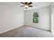Cozy bedroom featuring a ceiling fan, neutral walls, and a bright window at 820 Cypress Oak Cir, Deland, FL 32720