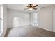 Carpeted bedroom with ceiling fan and neutral colored wall at 820 Cypress Oak Cir, Deland, FL 32720