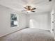 Bedroom with neutral carpet, paint and a window showing the outdoors at 820 Cypress Oak Cir, Deland, FL 32720