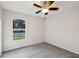 Well-lit bedroom features a ceiling fan, neutral walls, and a bright window at 820 Cypress Oak Cir, Deland, FL 32720