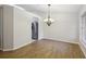 Light-filled dining room featuring wood-look floors and a decorative chandelier at 820 Cypress Oak Cir, Deland, FL 32720