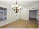Inviting dining room features wood-look tile floors and an elegant chandelier at 820 Cypress Oak Cir, Deland, FL 32720