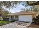Front exterior of home with garage and landscaped front yard with covered porch at 820 Cypress Oak Cir, Deland, FL 32720