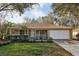 Charming single-story home with well-manicured lawn and inviting front porch at 820 Cypress Oak Cir, Deland, FL 32720