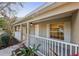 Covered front porch showcasing white railing and view into the home's living space at 820 Cypress Oak Cir, Deland, FL 32720