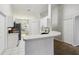 Open-concept kitchen with stainless steel appliances and a breakfast bar overlooking a dining area at 820 Cypress Oak Cir, Deland, FL 32720