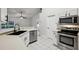 Modern white kitchen with stainless steel appliances and a sleek black faucet at 820 Cypress Oak Cir, Deland, FL 32720