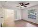 Spacious living room with wood-look tile floors, ceiling fan, and french doors at 820 Cypress Oak Cir, Deland, FL 32720