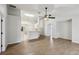 Open-concept living room with wood-look flooring and modern ceiling fan fixture at 820 Cypress Oak Cir, Deland, FL 32720
