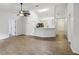 Bright living area with wood-look flooring and view into the kitchen bar at 820 Cypress Oak Cir, Deland, FL 32720