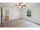 Light and airy carpeted bedroom with window overlooking green backyard at 820 Cypress Oak Cir, Deland, FL 32720