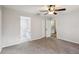 Spacious carpeted bedroom with a ceiling fan and views into the bathroom and kitchen at 820 Cypress Oak Cir, Deland, FL 32720