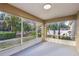 This home features a screened porch and a view of lush landscaping at 820 Cypress Oak Cir, Deland, FL 32720