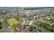Neighborhood aerial view featuring mature trees, community park, tennis court, and single Gathering homes at 8515 Morehouse Dr, Orlando, FL 32836