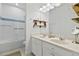 Bright bathroom with double vanity sink, mirror, and combined tub and shower at 8515 Morehouse Dr, Orlando, FL 32836