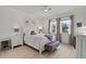 Bright bedroom boasts natural light, a cozy bed, a bench, and a sleek workspace at 8515 Morehouse Dr, Orlando, FL 32836