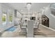 Bright dining area with a large table, seating for ten, neutral decor, and seamless flow to the kitchen at 8515 Morehouse Dr, Orlando, FL 32836