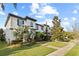 Charming two-story home with lush landscaping, a stone accent wall, and a well-maintained front yard at 8515 Morehouse Dr, Orlando, FL 32836