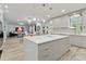 Open floor plan featuring a modern kitchen with a large island that flows into the dining and living areas at 8515 Morehouse Dr, Orlando, FL 32836