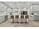 Modern kitchen featuring an island with seating, sleek cabinets, and stainless steel appliances at 8515 Morehouse Dr, Orlando, FL 32836
