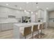 Modern kitchen featuring a large island with bar seating, and sleek cabinetry at 8515 Morehouse Dr, Orlando, FL 32836