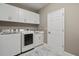 Well-equipped laundry room with modern washer and dryer, cabinetry, and a sink for convenience at 8515 Morehouse Dr, Orlando, FL 32836