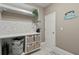 Functional laundry room with countertop space, storage shelves, and decor for a tidy space at 8515 Morehouse Dr, Orlando, FL 32836