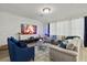 Cozy living room with a textured white accent wall, plush seating, modern fireplace, and soft, neutral tones at 8515 Morehouse Dr, Orlando, FL 32836