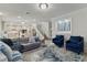 Open-concept living room with modern furnishings, a comfortable gray sofa, and lots of natural light from the windows at 8515 Morehouse Dr, Orlando, FL 32836