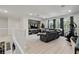Open concept living room features built-in shelving, TV, comfortable seating, and bright windows at 8515 Morehouse Dr, Orlando, FL 32836