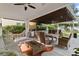 Inviting outdoor living area with a cozy lounge, dining space, and fully equipped outdoor kitchen and barbeque at 8515 Morehouse Dr, Orlando, FL 32836